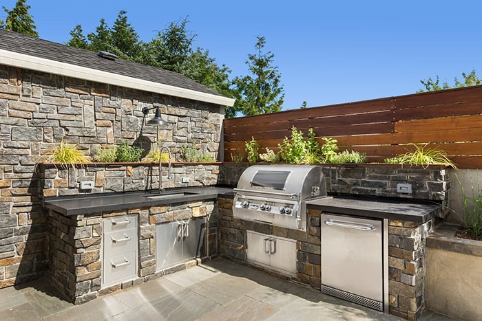 Stone accents in outdoor kitchen and BBQ areas blend functionality with style