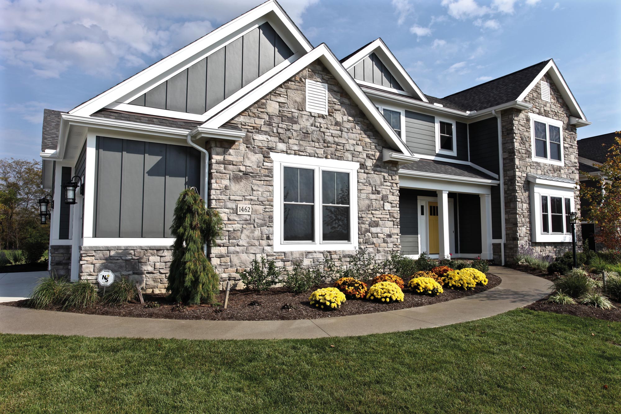 Stone accents at entryways create a striking and inviting visual impression